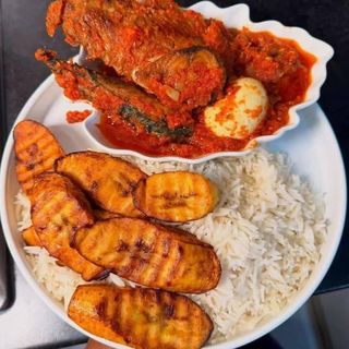 White rice and plantains served with 2 titus fish mixed with boiled egg