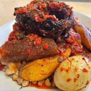 Oloyin beans porridge served with plantains peppered pomo titus and boiled egg