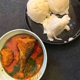 Pounded yam served with ewedu mixed with titus fish and beef