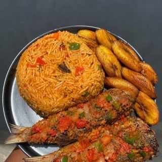 Jollof rice with plantains served with 2 croaker fish