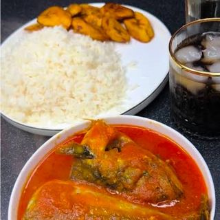 Titus fish in peppered sauce served with white rice and plantains