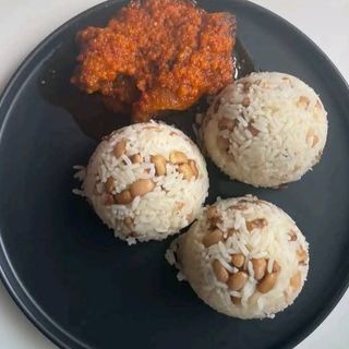 White rice mixed with oloyin beans served with spicy beef stew