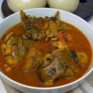 Catfish in spicy Nigerian sauce served with semolina