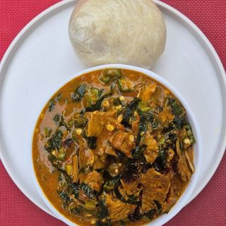 Pounded yam served with ogbono mixed with okro and Assorted beef, pomo, chicken