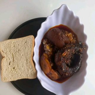 Spicy oloyin beans,pomo,titus fish with agege Bread