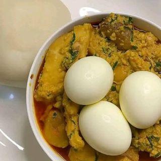 Pounded yam served with egusi mixed with pomo and 3 boiled eggs 