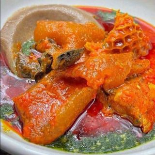 Amala served with ewedu mixed with shaki pomo and goatmeat