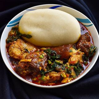 Pounded yam served with okro mixed with croaker fish pomo beef shaki