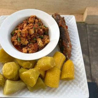 Boiled plantains and sweet potatoes served with scrambled eggs with peppered titus fish