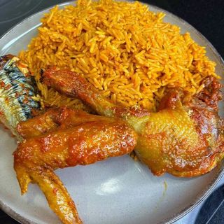 Jollof rice served with sauces titus fish mixed with Traditional Chicken