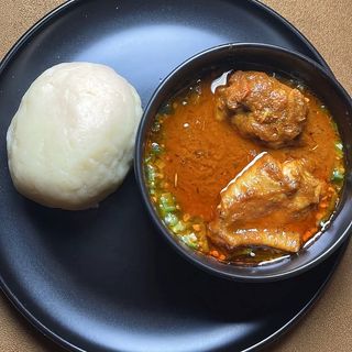 Semolina served with okro mixed with cowleg and chicken 