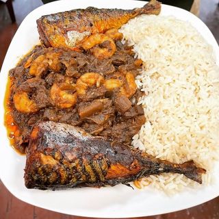 White rice served with 2 titus fish in spicy Nigerian sauce