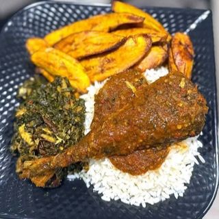 White rice and plantains served with titus fish and eforiro vegetables