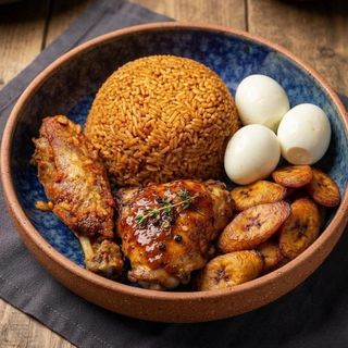 Jollof rice with plantains served with Turkey wing and 3 boiled eggs