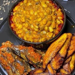 Oloyin beans porridge served with plantains and peppered croaker fish