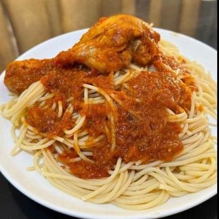 Boiled Sphaghetti served with chicken drumstick in Nigerian spicy sauce