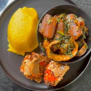 Yellow Eba served with eforiro mixed with pomo beef and croaker fish