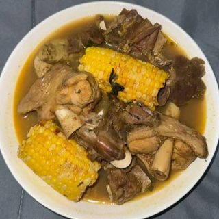 Boiled goatmeat peppe soup mixed with boiled sweetcorn