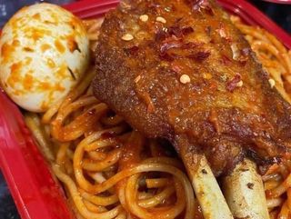 Turkey wing, boiled egg and peppered Jollof Sphaghetti