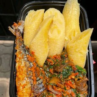 Boiled plantains served with eforiro mixed with pomo and titus fish