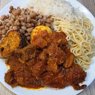 Half white rice Half white oloyin beans Half boiled Sphaghetti served with titus fish in spicy sauce and boiled egg