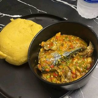 Yellow Eba served with titus and croaker fish mixed with okro
