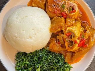 White ugali served with spicy cowlegs and sukuma