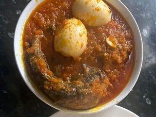 Titus fish mixed with 2 boiled eggs in Nigerian spicy stew