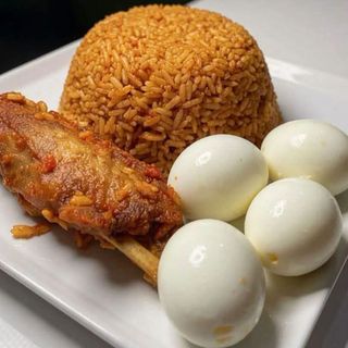 Jollof rice served with 4 boiled eggs and turkey wing