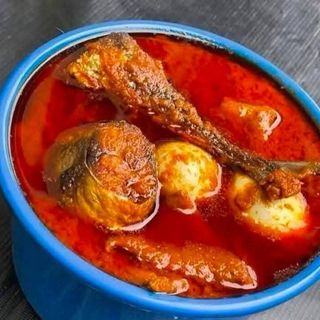 2 Titus fish in spicy Nigerian sauce mixed with 2 boiled eggs