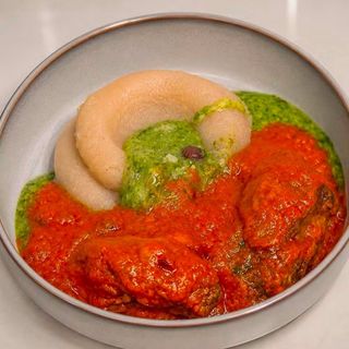 White Eba served with okro mixed with peppered croaker fish and goatmeat sauce
