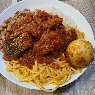 Half White rice, Half white oloyin beans, Half Sphaghetti served with 2 croaker fish with 1 boiled egg