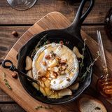 Baguette with baked Camembert cheese and seasonal fruits