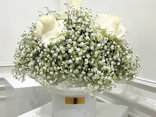 Box with baby breath and white roses