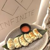 Gyoza with spinach and ricotta cheese served with hot honey