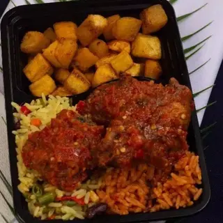 Jollof and Fried Rice Served with Meat and Plantain