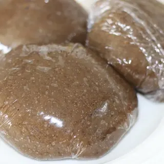 Two wraps of Black Amala With 2 Ponmo and 2 beefs and any soup of choice (Ewedu/Egusi)