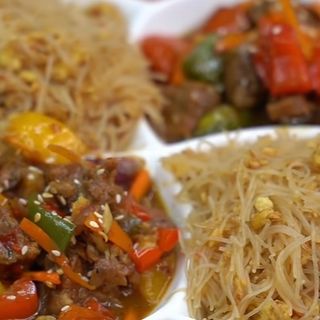 Goat meat in teriyaki sauce and egg fried Singapore noodles