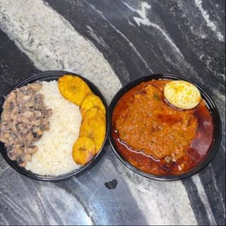 Rice and beans with plantain, boiled egg, and chicken