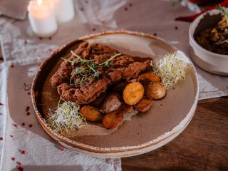 Kotlet schabowy z kością z pieczonymi ziemniakami i kapustą kiszoną