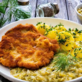 Kotlet schabowy z ziemniakami i zestawem surówek