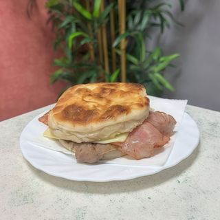 Prego no Bolo do Caco com queijo e bacon