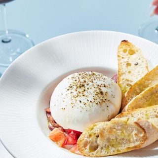 Burrata Italiana served with tomatoes and kalamata burschetta