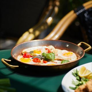 Mix of eggs served with duck breast and cherry tomatoes