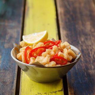 Calamari with a zing served with lemon, salt & chilli