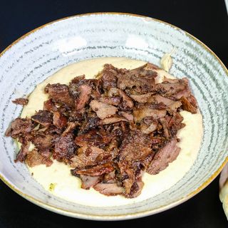 Hummus with beef shawarma in plate
