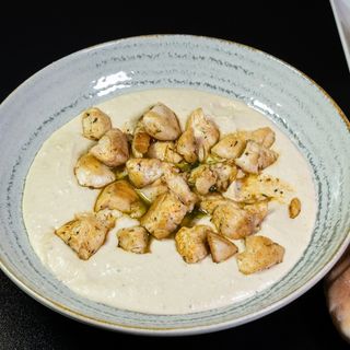 Hummus with chicken in plate
