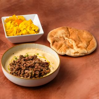 Hummus with beef shawarma in plate