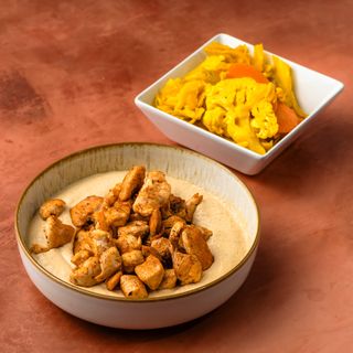 Hummus with chicken in plate