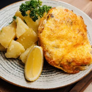 Fish baked with mushrooms and cheese, and potatoes